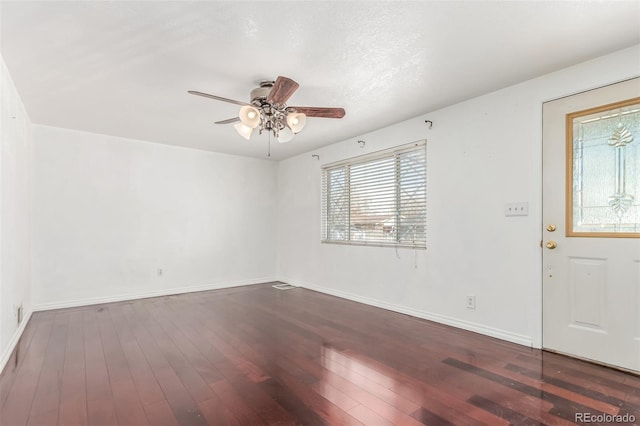 empty room featuring ceiling fan and dark hardwood / wood-style flooring