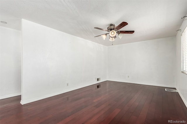 spare room featuring dark hardwood / wood-style flooring and ceiling fan