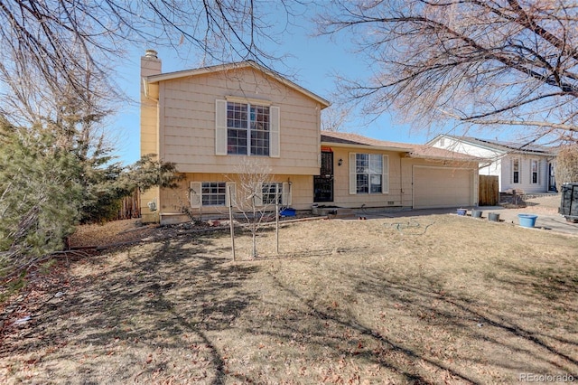 view of front of property with a garage and a front yard