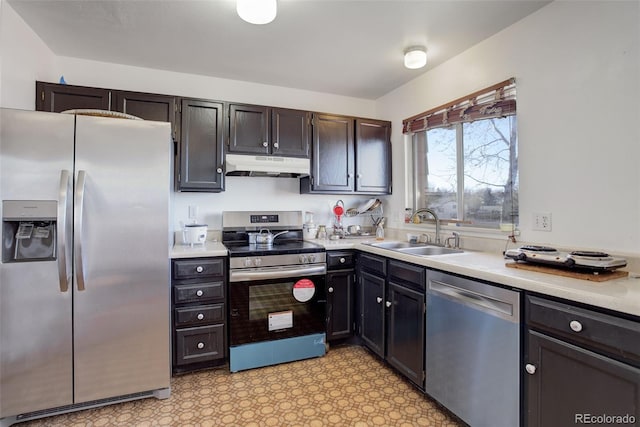 kitchen with dark brown cabinetry, sink, and stainless steel appliances