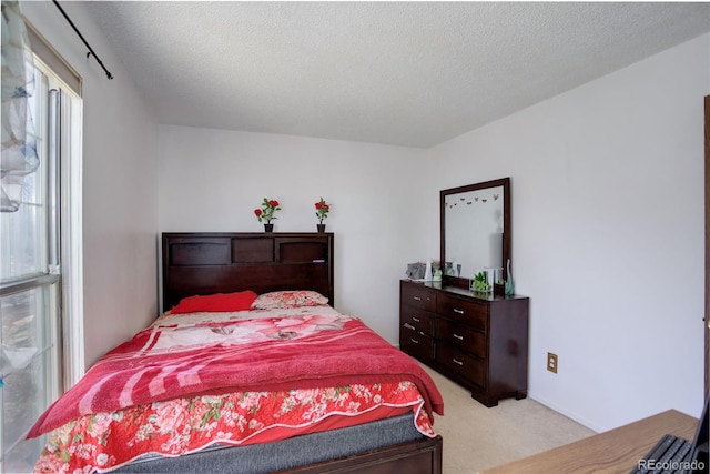 carpeted bedroom with a textured ceiling