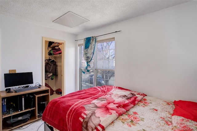 bedroom with a closet, a spacious closet, and a textured ceiling