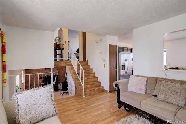 living room featuring light hardwood / wood-style floors and a textured ceiling