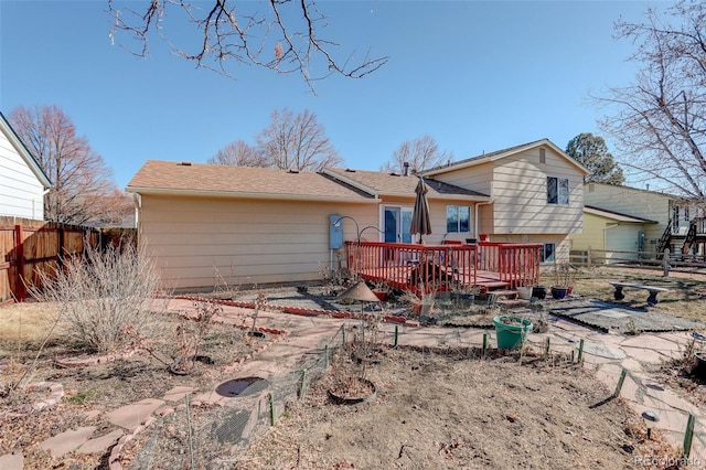 rear view of house featuring a deck