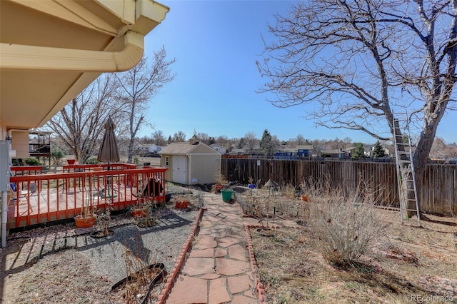 view of yard featuring a deck and a shed