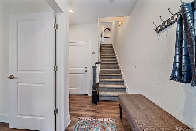 stairway with recessed lighting, baseboards, and wood finished floors