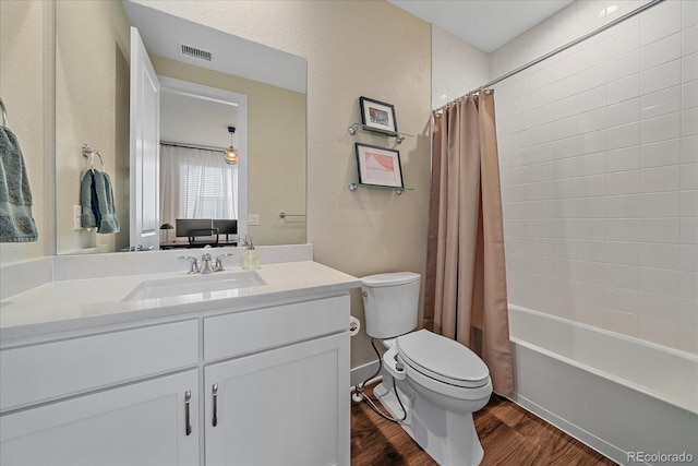 5189 Vivian St, Wheat Ridge, CO 80033 - full bathroom featuring wood finished floors, vanity, shower / bath combination with curtain, and a textured wall