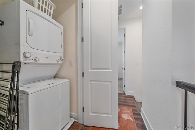 5189 Vivian St, Wheat Ridge, CO 80033 - laundry area with stacked washer and clothes dryer and dark wood-style flooring
