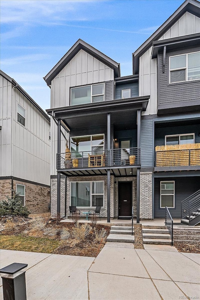 5189 Vivian St, Wheat Ridge, CO 80033 - view of front of house with a balcony and board and batten siding