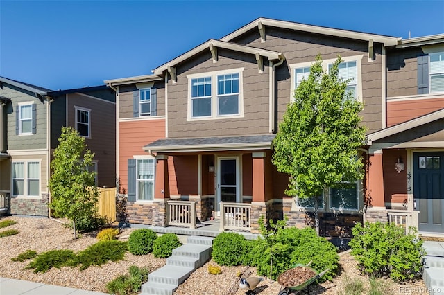 craftsman house with covered porch and stone siding