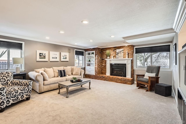 living room featuring plenty of natural light, light carpet, a fireplace, and a textured ceiling