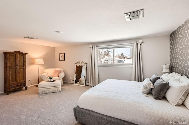 bedroom with light carpet, visible vents, and baseboards