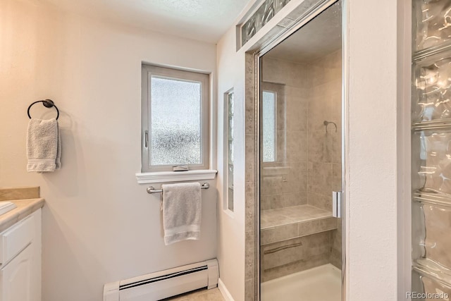 bathroom with a baseboard heating unit, a shower stall, and vanity