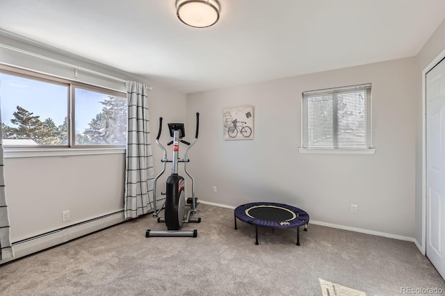 exercise area with light carpet, a baseboard radiator, and baseboards