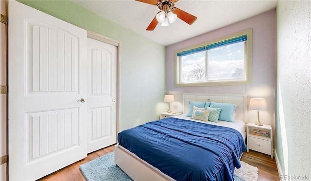 bedroom with a ceiling fan and wood finished floors