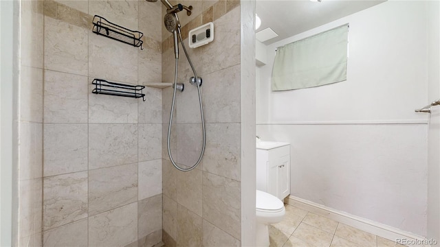 full bath with vanity, tile patterned flooring, a tile shower, and toilet