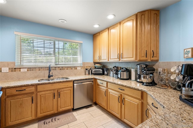 kitchen with a sink, light stone counters, backsplash, recessed lighting, and dishwasher