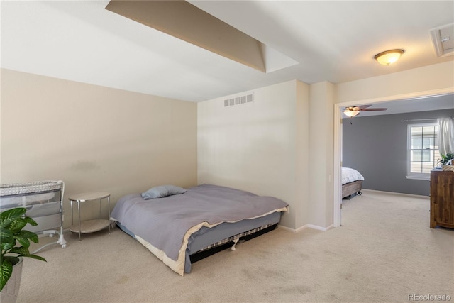 carpeted bedroom featuring baseboards and visible vents