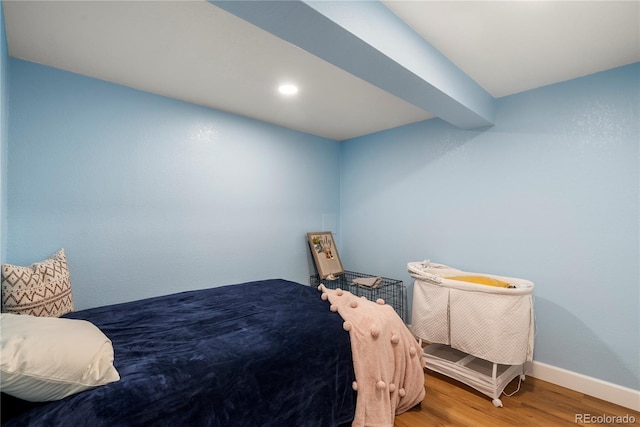 bedroom with recessed lighting, baseboards, and wood finished floors