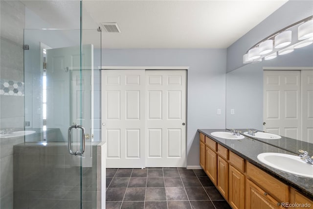 bathroom with a sink, visible vents, and a stall shower