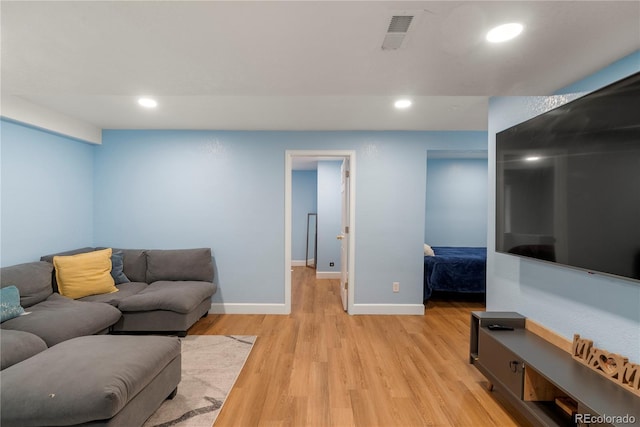 living area with recessed lighting, visible vents, baseboards, and light wood-style floors