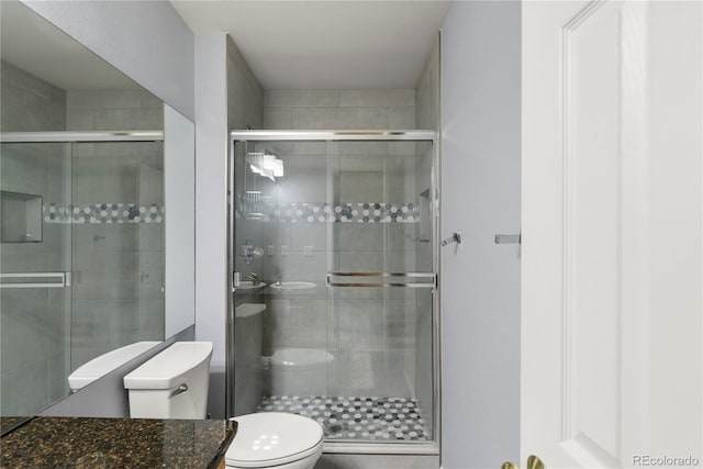 bathroom with toilet and a stall shower