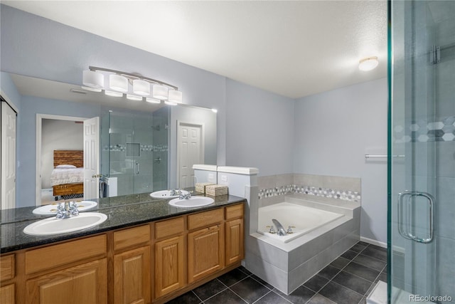 ensuite bathroom with a garden tub, a stall shower, a sink, connected bathroom, and tile patterned flooring