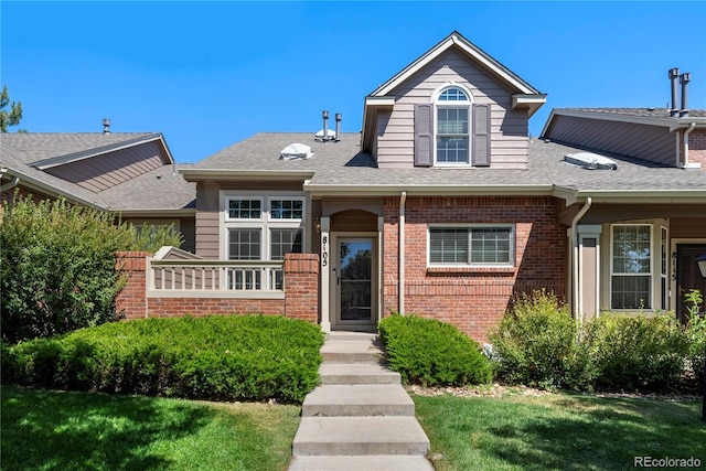 8105 E Bayaud Ave, Denver, CO 80230 - view of front of property featuring brick siding, a shingled roof, and a front yard
