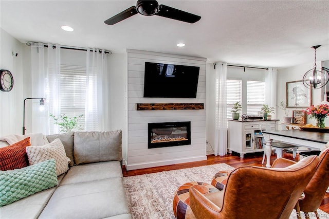 21418 E Stroll Ave, Parker, CO 80138 - living room with ceiling fan, wood finished floors, a fireplace, and recessed lighting