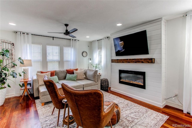 21418 E Stroll Ave, Parker, CO 80138 - living area with ceiling fan, wood finished floors, a fireplace, recessed lighting, and baseboards