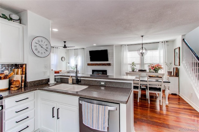 21418 E Stroll Ave, Parker, CO 80138 - kitchen with dishwashing machine, a sink, open floor plan, dark countertops, and ceiling fan