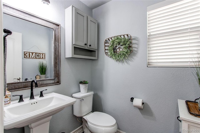 21418 E Stroll Ave, Parker, CO 80138 - half bathroom featuring a sink, toilet, baseboards, and a textured wall