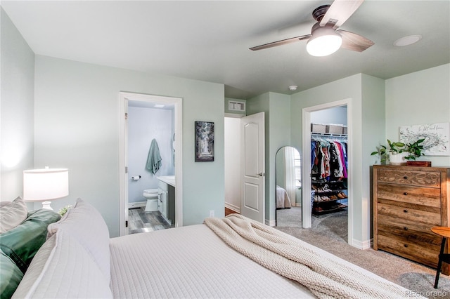 21418 E Stroll Ave, Parker, CO 80138 - bedroom featuring a spacious closet, a closet, ensuite bathroom, and baseboards