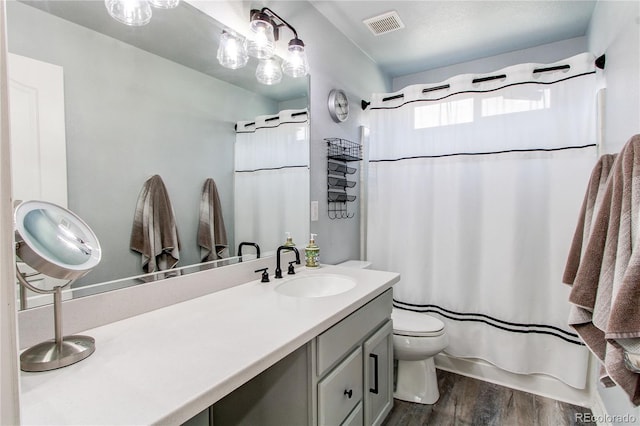 21418 E Stroll Ave, Parker, CO 80138 - full bathroom with wood finished floors, vanity, toilet, and curtained shower
