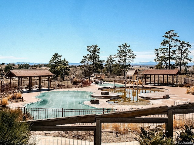 21418 E Stroll Ave, Parker, CO 80138 - community pool featuring a gazebo, a water slide, and a patio area