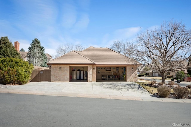 view of front of home with a garage, brick siding, and driveway