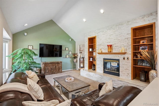 carpeted living room featuring a stone fireplace, vaulted ceiling, built in shelves, and baseboards