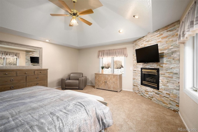 bedroom featuring a stone fireplace, baseboards, carpet, and vaulted ceiling