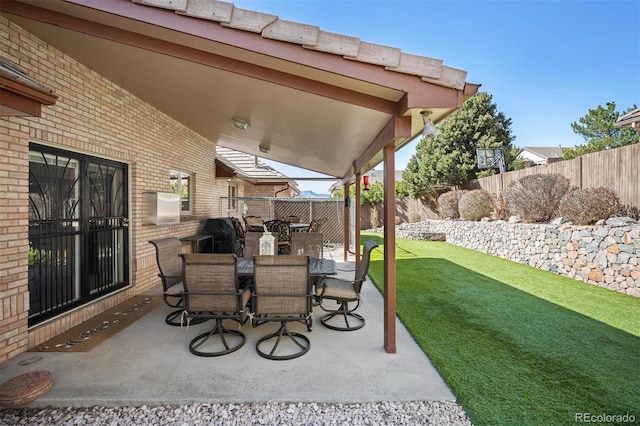 view of patio / terrace featuring a grill, outdoor dining area, and a fenced backyard