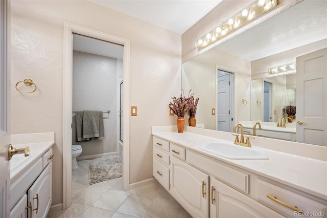 full bath featuring baseboards, enclosed tub / shower combo, toilet, and vanity