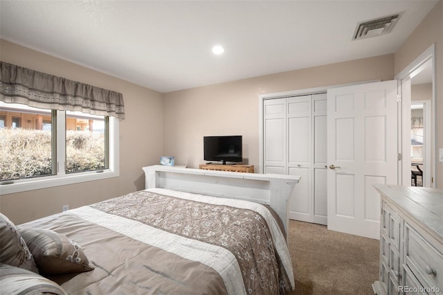 carpeted bedroom featuring a closet, visible vents, and recessed lighting