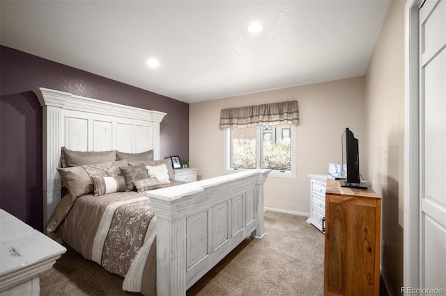 bedroom featuring baseboards and light colored carpet