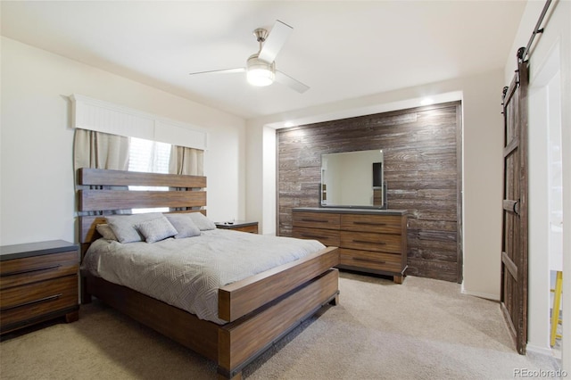 62069 Jade Rd, Montrose, CO 81401 - bedroom with a barn door, light carpet, and a ceiling fan