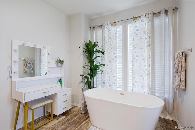 62069 Jade Rd, Montrose, CO 81401 - bathroom featuring a freestanding bath, baseboards, and wood finished floors