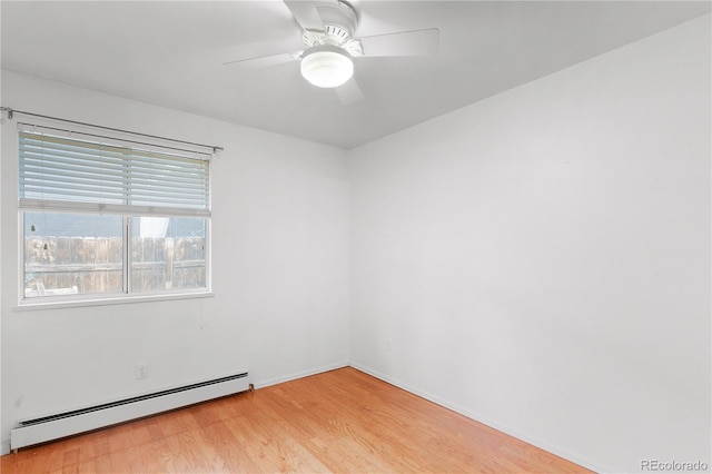 empty room featuring light wood-type flooring, a baseboard heating unit, and a ceiling fan