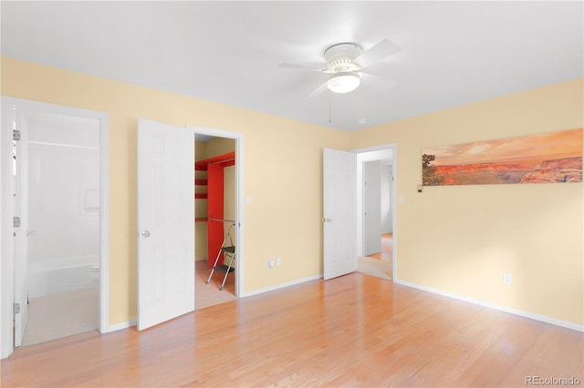 unfurnished room with baseboards, light wood-type flooring, and ceiling fan