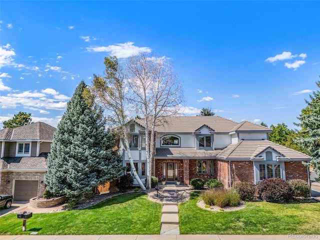 front of property with a front yard and a garage