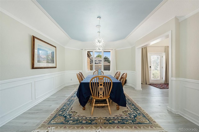 dining room featuring a healthy amount of sunlight, a chandelier, and light hardwood / wood-style flooring