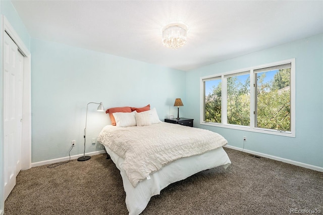 bedroom featuring dark colored carpet and a closet