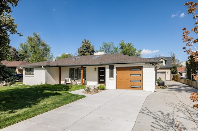 3540 Everett St, Wheat Ridge, CO 80033 - view of front facade with driveway, an attached garage, brick siding, and covered porch